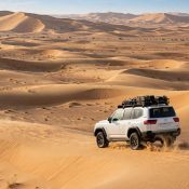 Desert safari 4x4 vehicle crossing golden dunes in Dubai