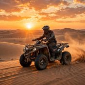 Quad bike rider on Dubai dunes at sunset